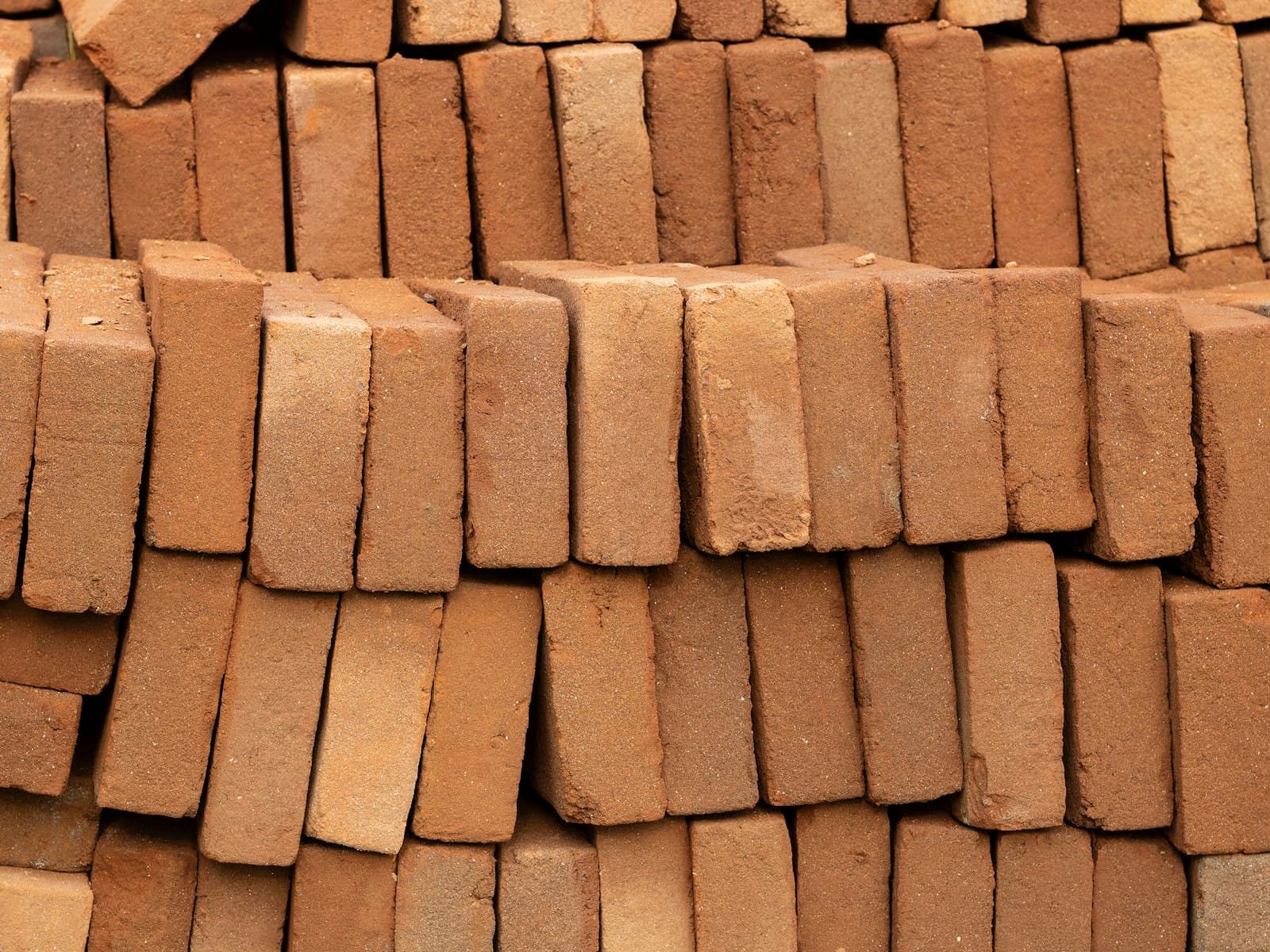Close-up of clay bricks stacked for masonry work