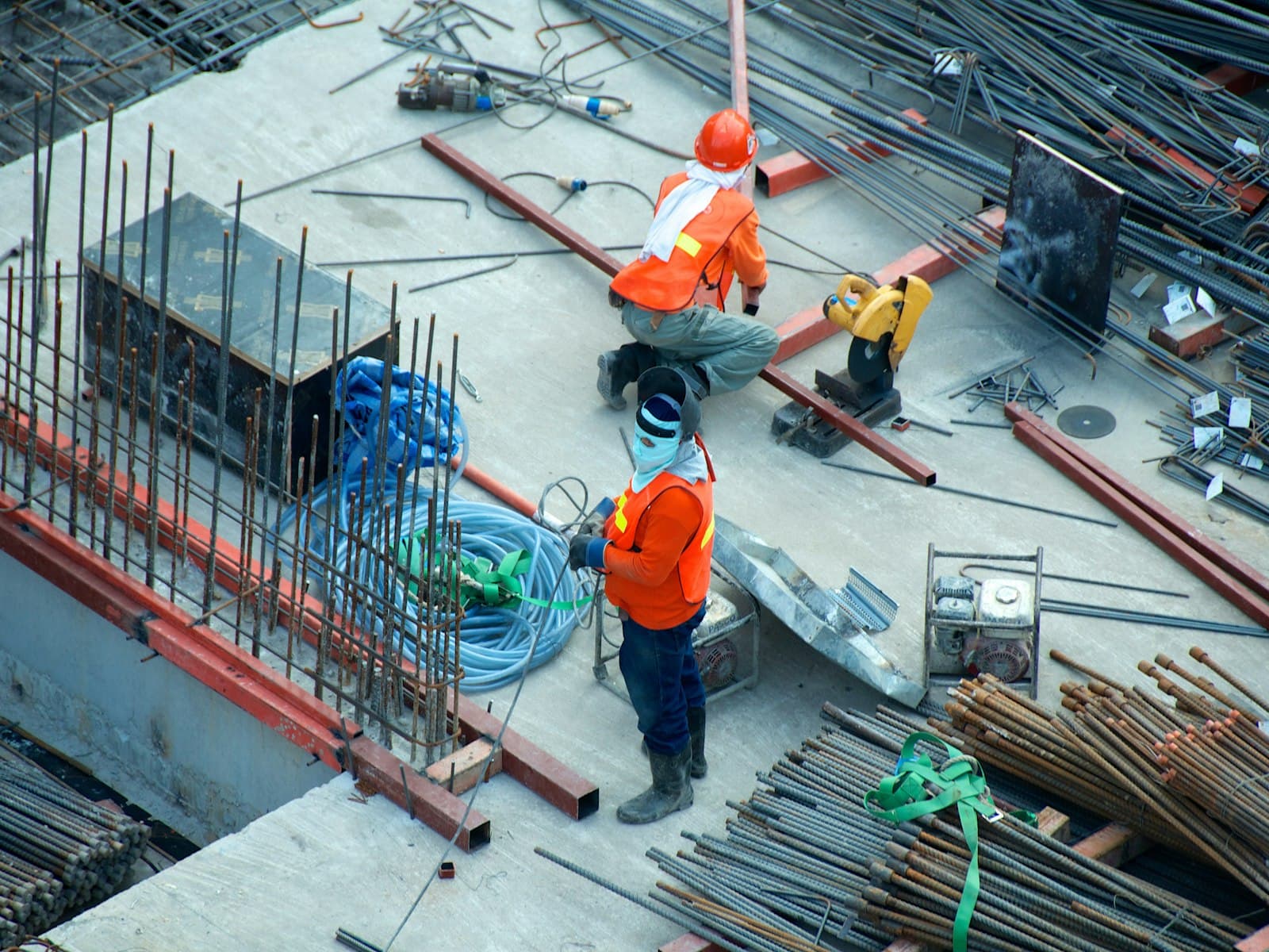 Construction workers wearing helmets and safety gear on site
